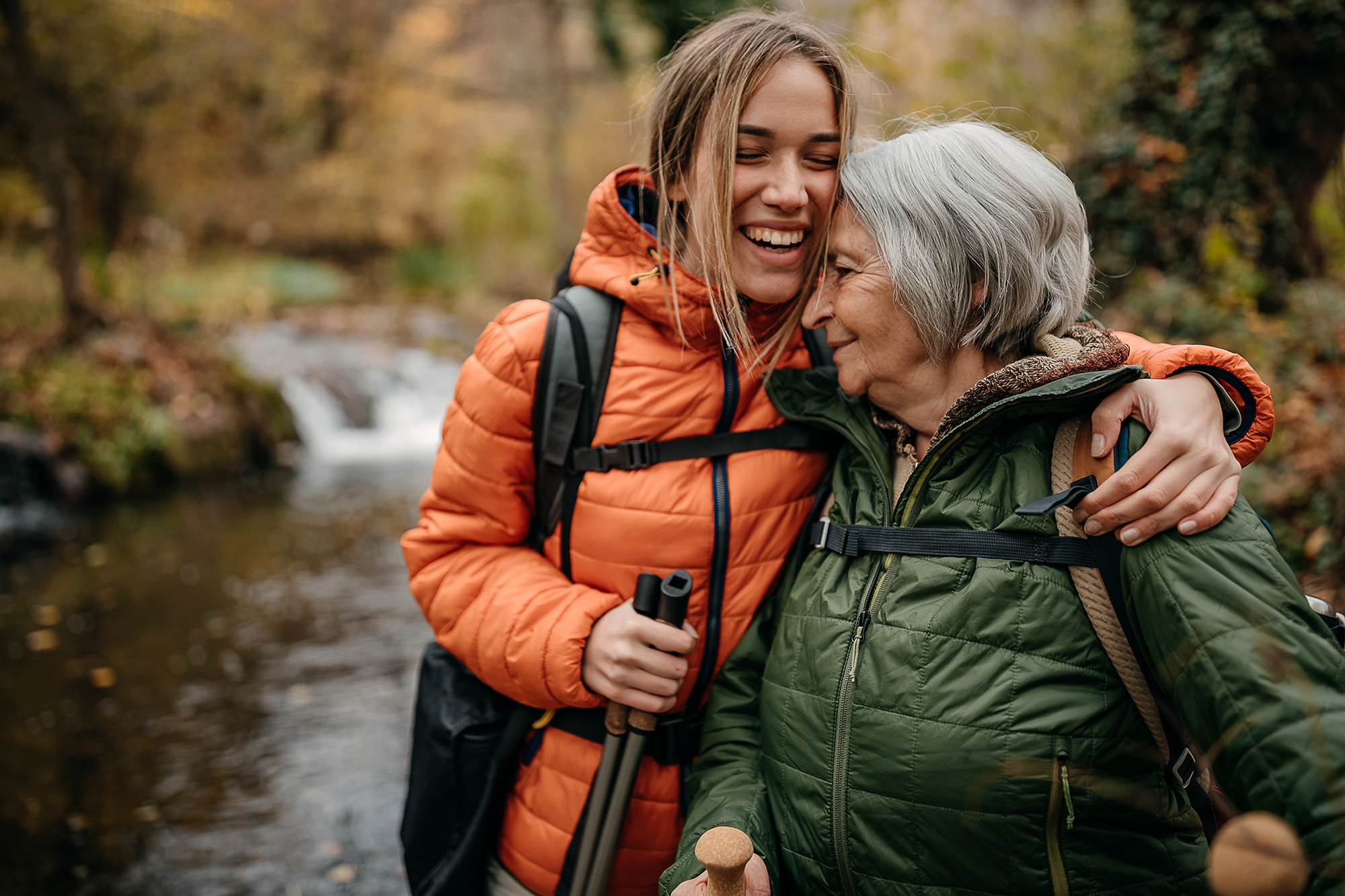 a mother and daughter smiling while on a hike