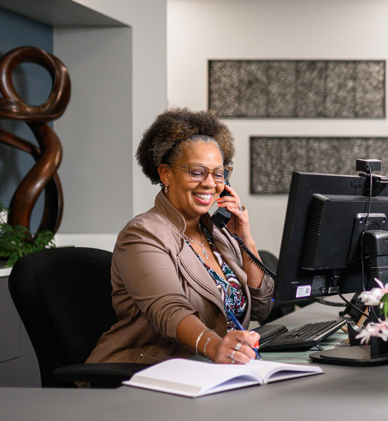 Kelly Pettit on phone at her desk