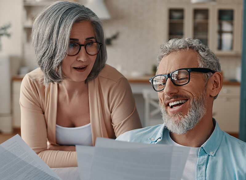 a couple happily reviewing documents at home