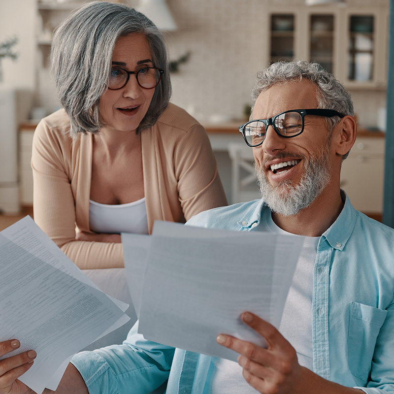 a couple happily reviewing documents at home