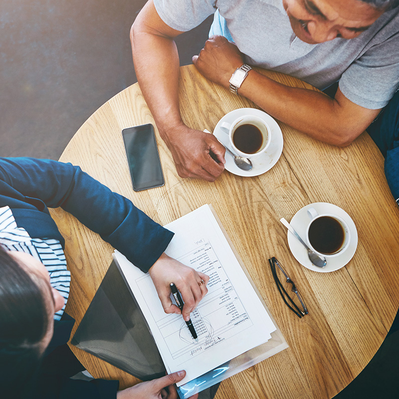 Couple meeting with advisor in coffee shop