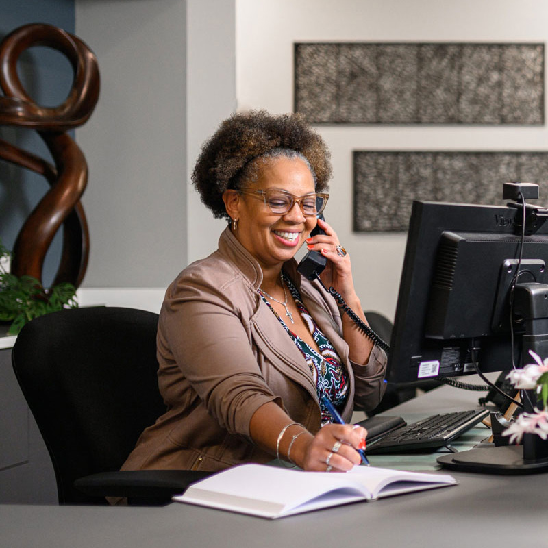 Kelly Pettit on phone at her desk